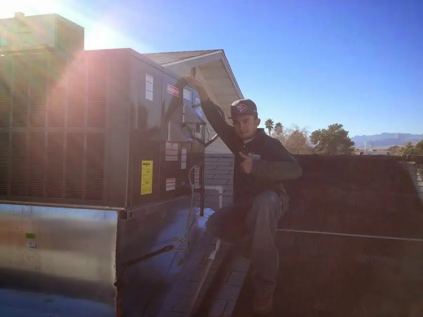HVAC technician performing Air Duct Repair on a rooftop unit in Eufaula